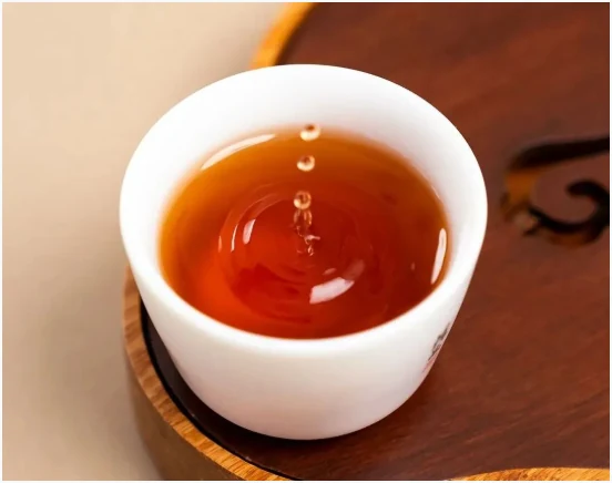 Amber Liubao tea in a white porcelain cup