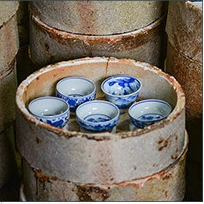 Workshop photograph of porcelain vessels inside protective saggars