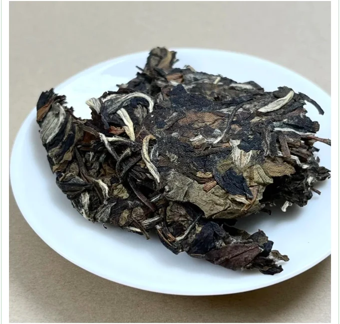 Broken pieces of a white tea cake on a white plate