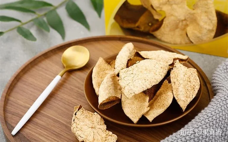 Dried peel on a wooden tray beside a spoon