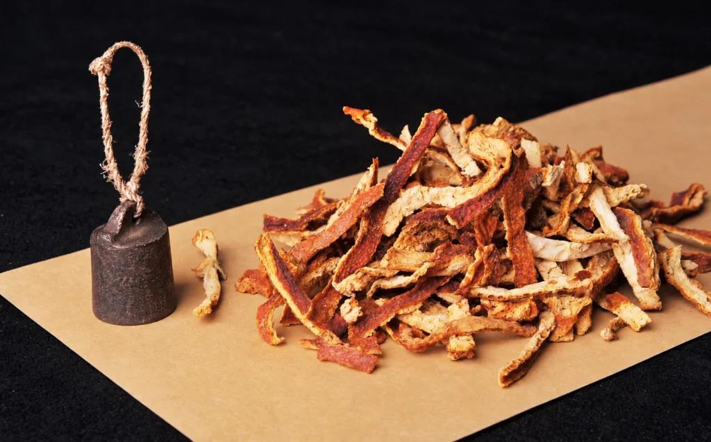 Dried tangerine peel strips on a paper mat