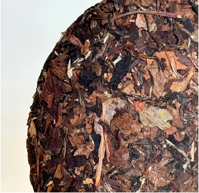 Close-up of the leafy edge of a pressed white tea cake
