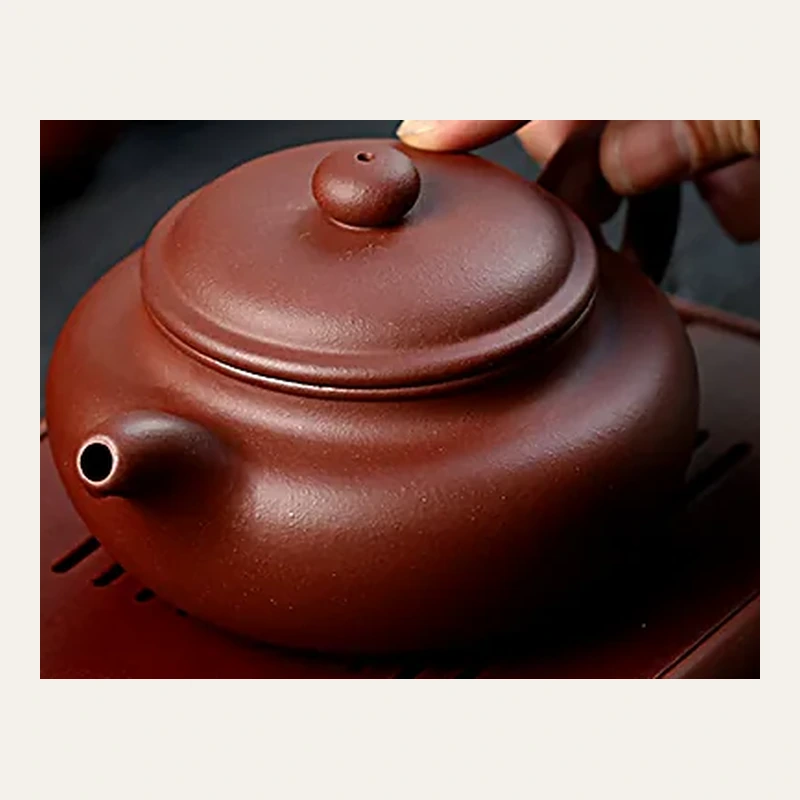 Three-quarter view of the rounded Fanggu teapot and lid
