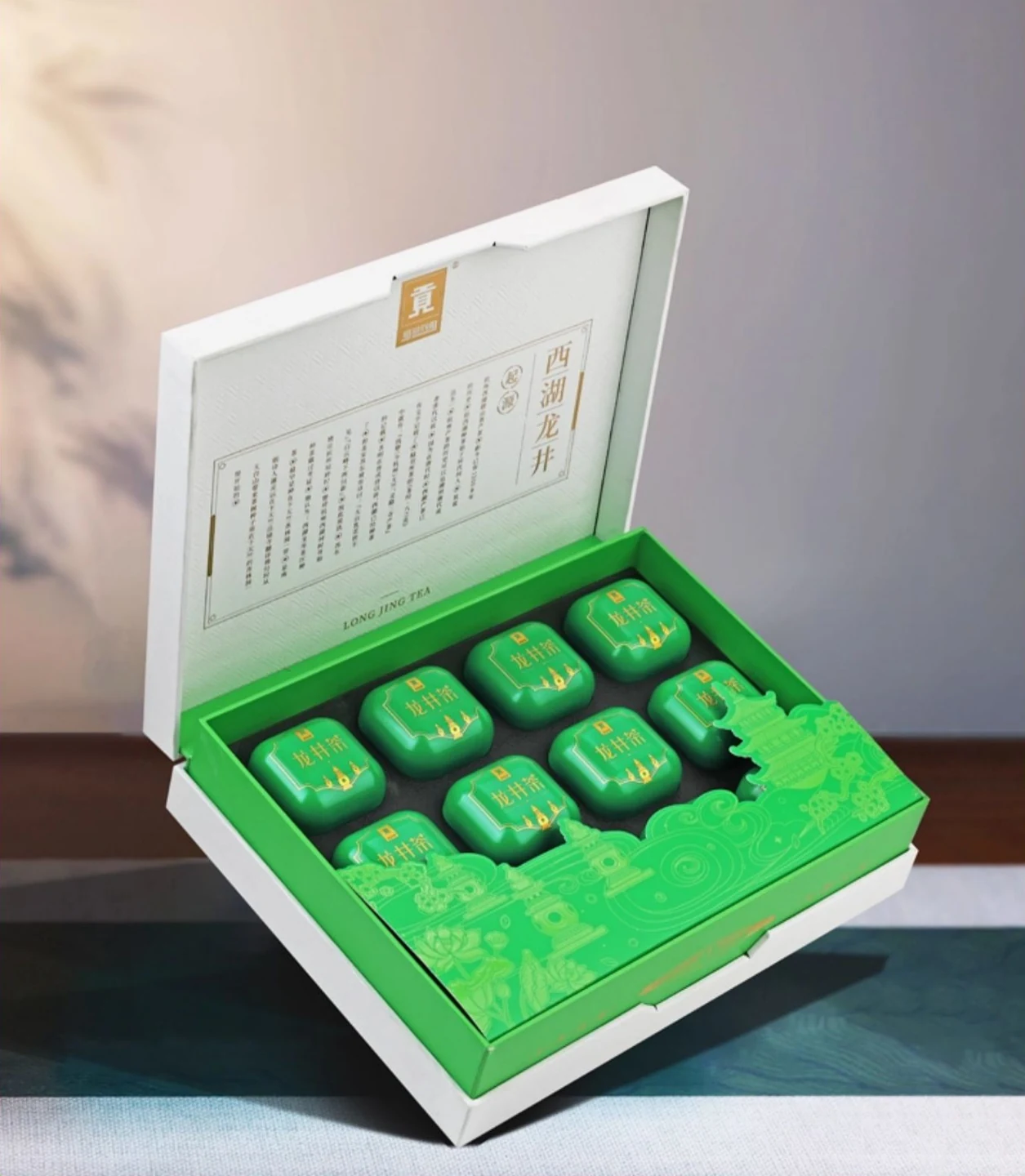 Open Longjing tea gift box showing individually packed green mini tins