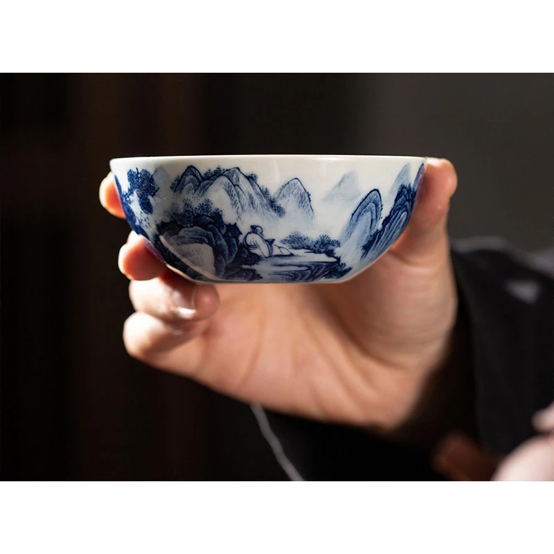 Landscape teacup held in a hand, showing its low bowl shape