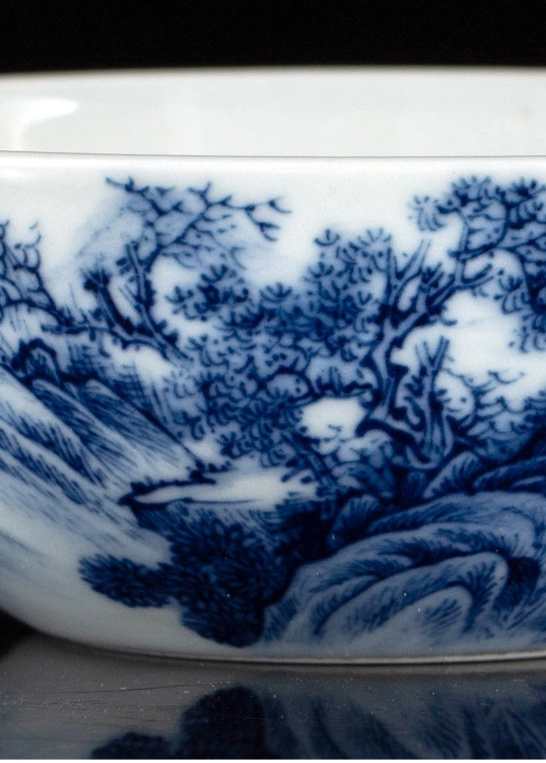 Close-up of blue tree branches, foliage and rock brushwork