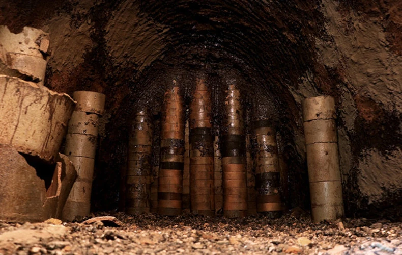 Interior of a brick-lined kiln with stacked ceramic saggars