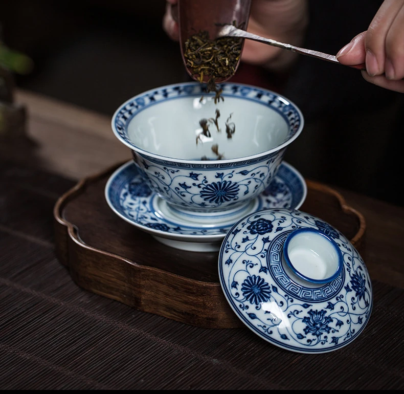 Tea leaves being added to the open lotus gaiwan