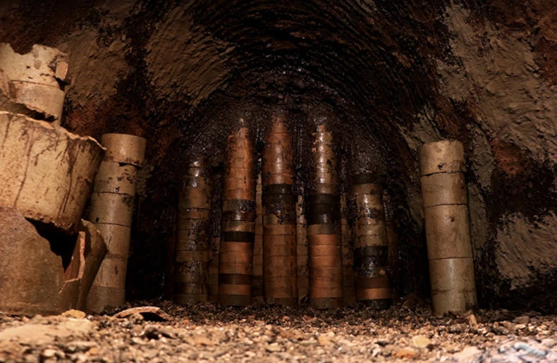 Interior of a traditional kiln with stacked cylindrical saggars