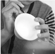 Hand painting a ceramic bowl