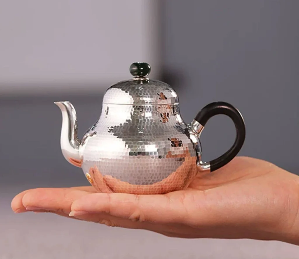 Si Ting Handmade 9999 Silver Teapot — 150mL — In-hand view for scale