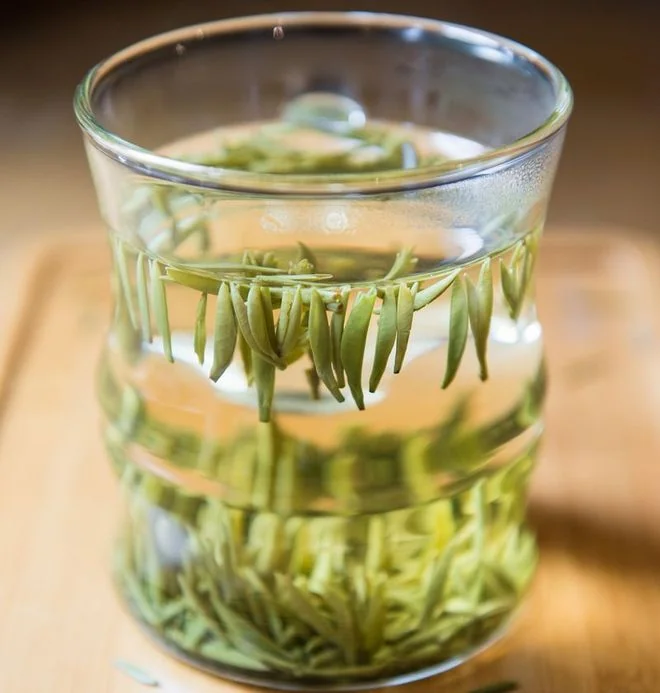 Longjing leaves infusing in a clear glass