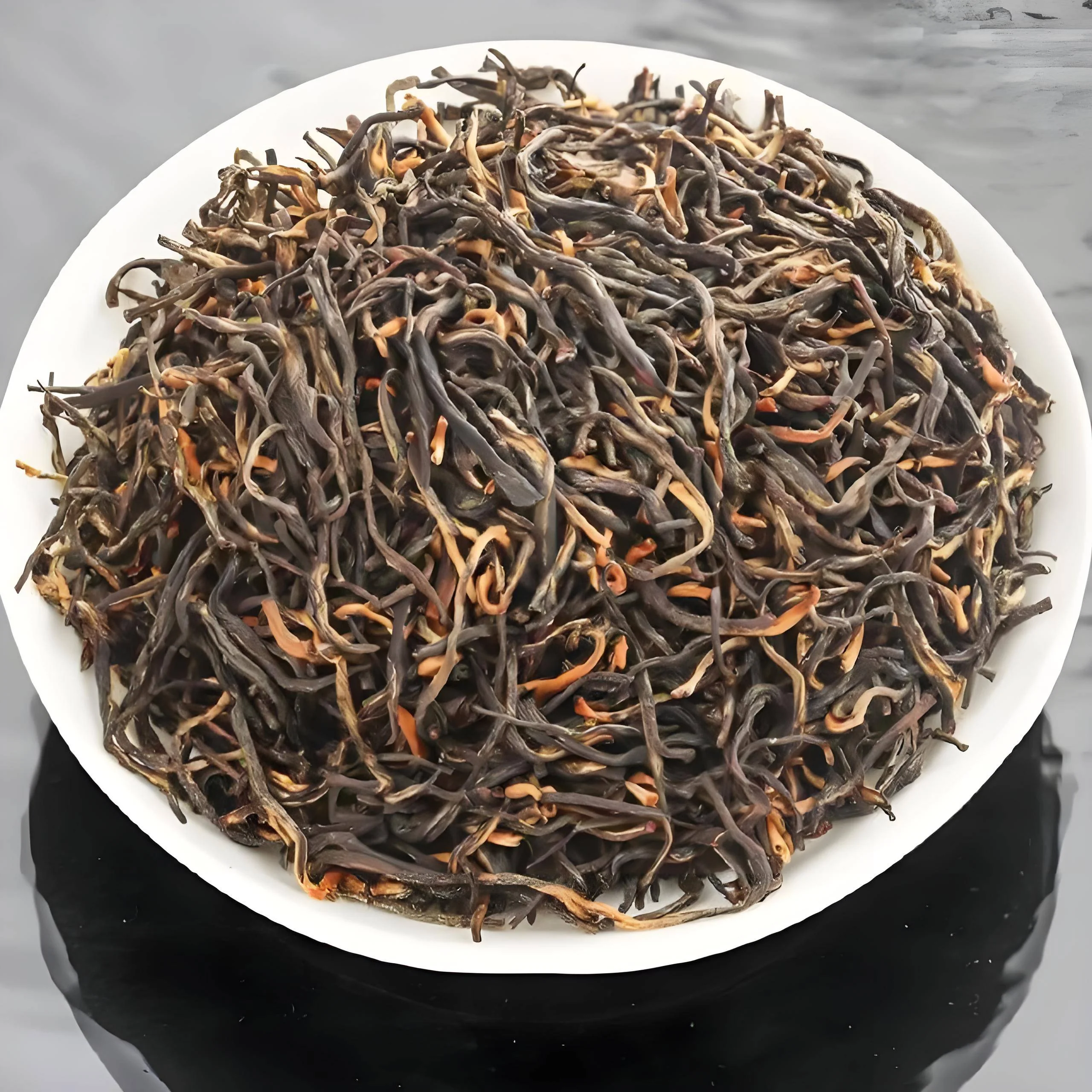 Dark and golden dry buds on a white plate