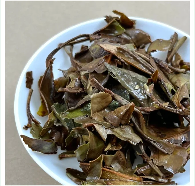 Large infused white tea leaves in a white bowl