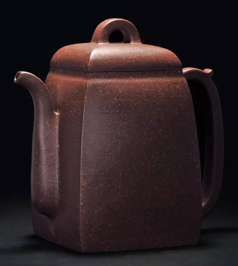 Tall square dark-brown teapot with rounded shoulders, a domed lid and arched knob