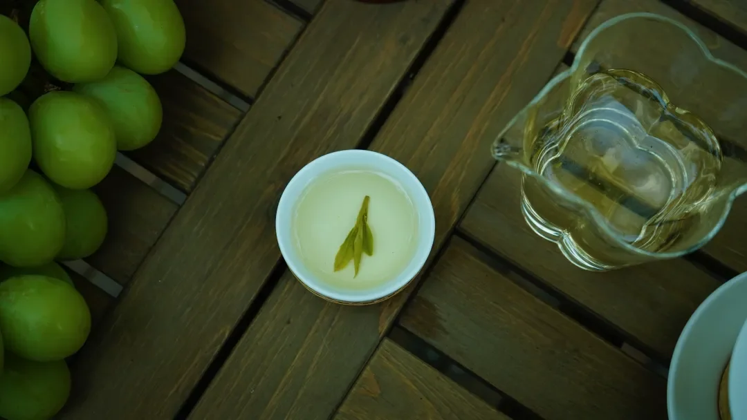 A tea cup and glass pitcher arranged for green tea tasting