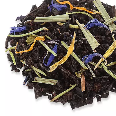 Black tea with green herb stems and blue and yellow flower petals