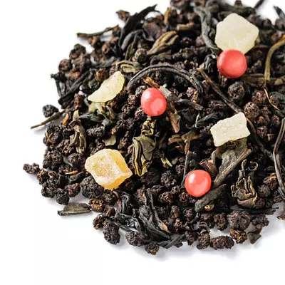 Black tea with dried fruit pieces and round pink peppercorns