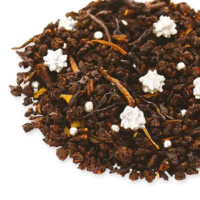 Dark tea leaves with silver-colored star decorations