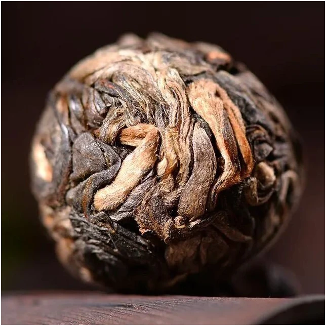 A small hand-rolled ball of compressed tea