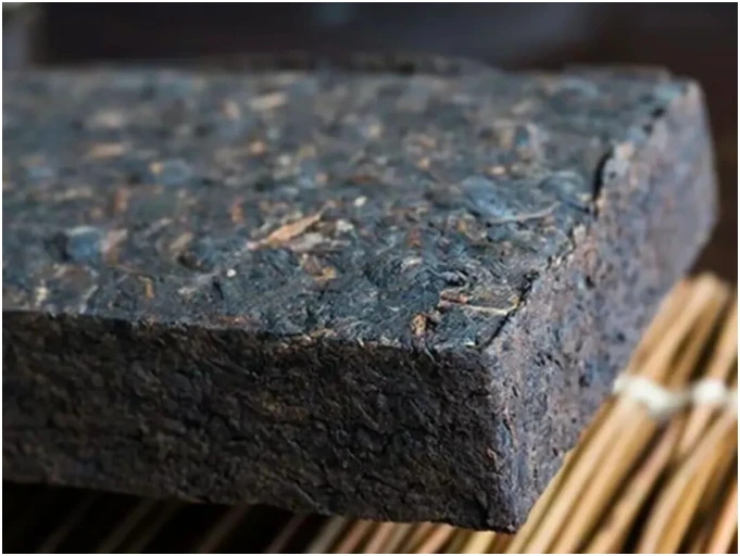 The corner and thick edge of a compressed tea brick