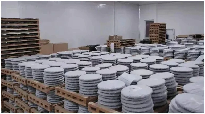 Stacks of compressed tea cakes in a storage room