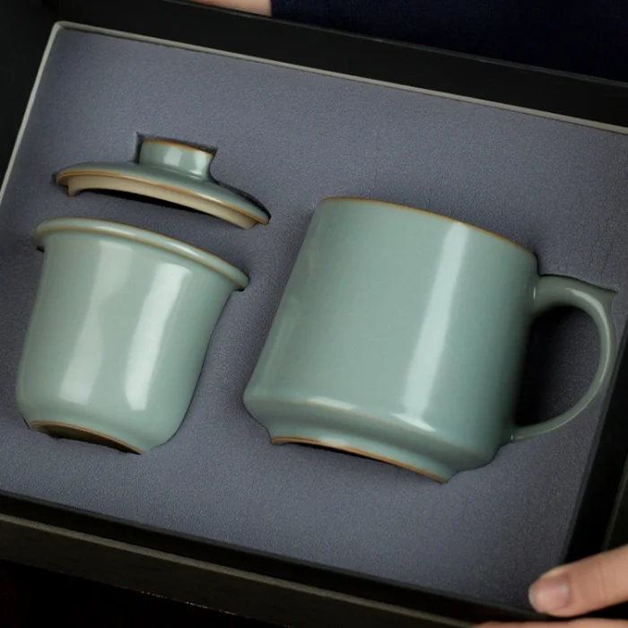 Mug, infuser and lid arranged in a presentation box