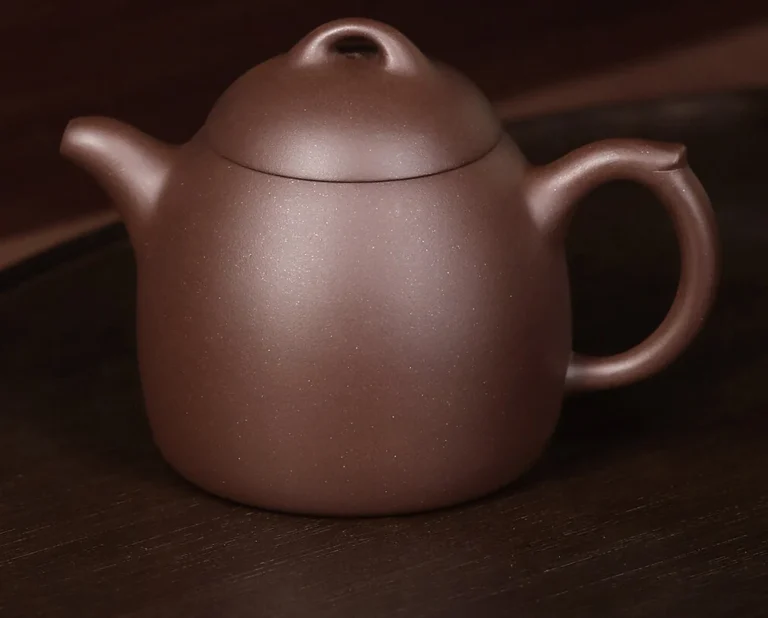Front view of a handmade 195 mL Qinquan Yixing teapot in Zi Ni purple clay
