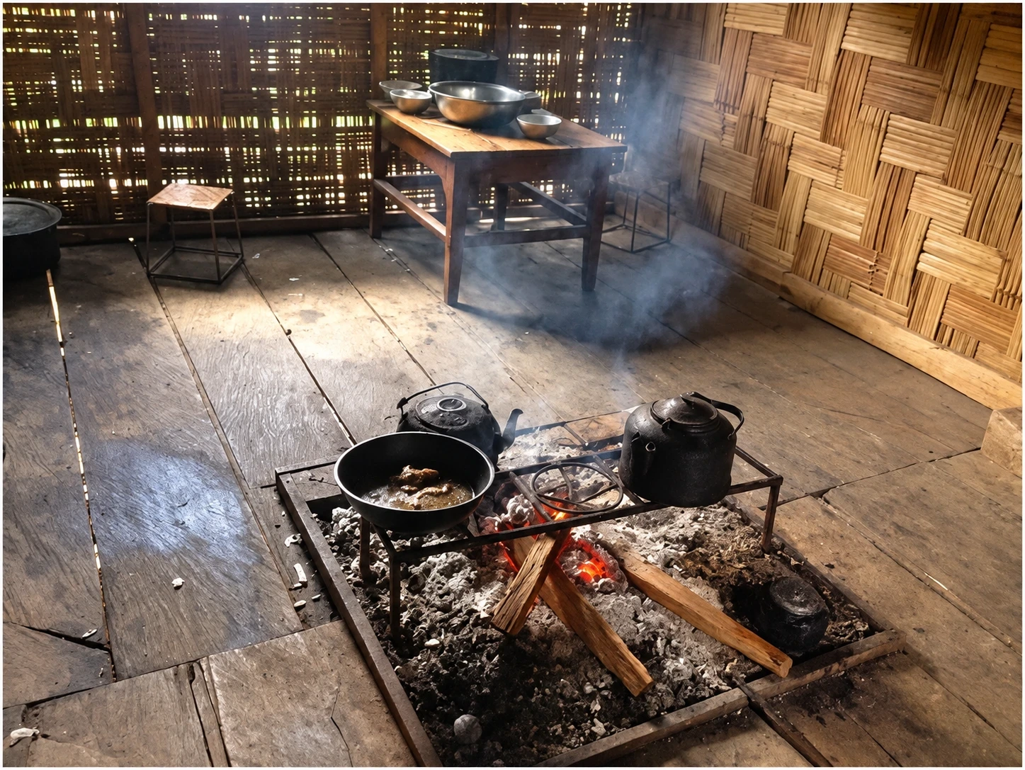A traditional household hearth with a kettle and cooking pan