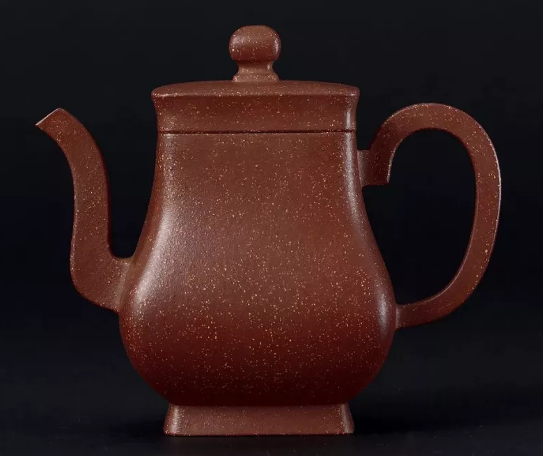 Tall four-sided reddish-brown teapot with a curving spout and large angular loop handle